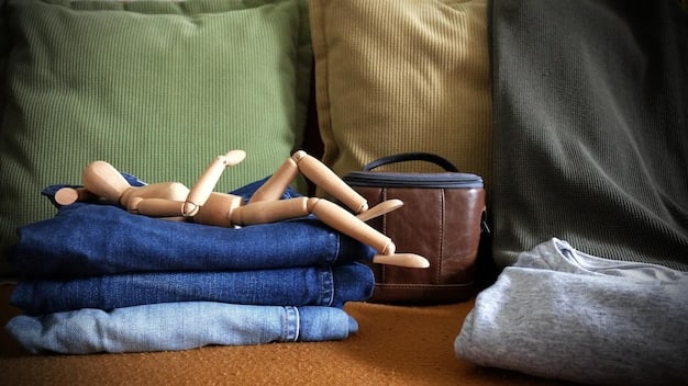 A close-up shot of a carefully arranged capsule wardrobe featuring neatly folded neutral-colored tops, jeans, and accessories, showcasing the concept of minimalist dressing.
