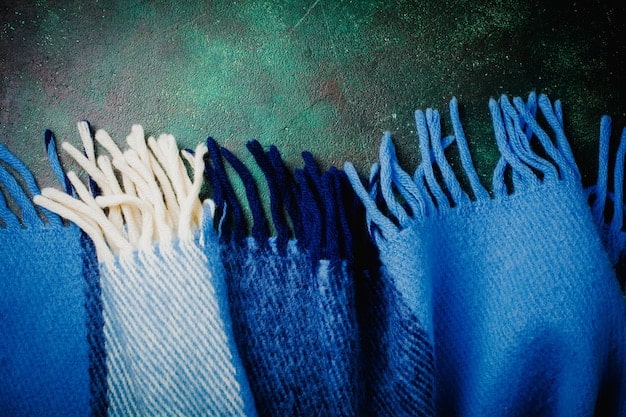 A close-up shot of various fabric textures and colors layered together, including denim, cotton, knitwear, and leather. The image emphasizes how different materials can complement each other in a layered outfit.