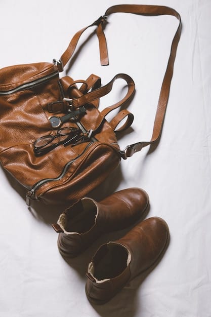 A collection of monochromatic accessories in various shades of brown, including a leather belt, a silk scarf, a woven handbag, and a pair of suede ankle boots. The image emphasizes how accessories can add depth and interest to a monochromatic outfit.