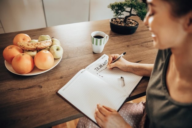 A person sitting at table with an open planner, mindfully writing down meal ideas for the week. The planner includes sections for breakfast, lunch, and dinner. The table is decorated with a small vase of flowers and a cup of tea.