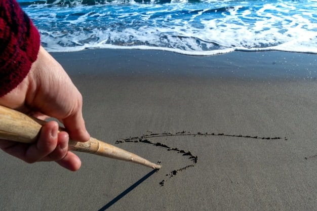 A person drawing a line in the sand on a beach with a stick, symbolizing the act of setting a clear boundary.