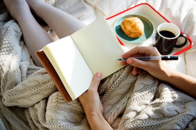 A close-up image of a hand writing in a journal with a pen. The background is blurred, showing a cozy and peaceful setting with a cup of tea and soft lighting.