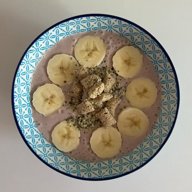 A top-down shot of a bowl of overnight oats topped with chia seeds, sliced bananas, blueberries, and a sprinkle of chopped walnuts. The oats are creamy, and the fruits are fresh and colorful, creating an appealing and nutritious breakfast option.