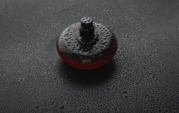 A macro shot of a perfume atomizer spraying a mist, with the focus on the droplets and their texture. The background is blurred, emphasizing the spray pattern and consistency.