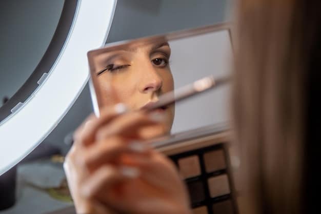 A woman expertly touching up her winged eyeliner with a fine-tipped liquid liner, demonstrating precision and focus, with makeup brushes and a compact mirror on a vanity in the background.