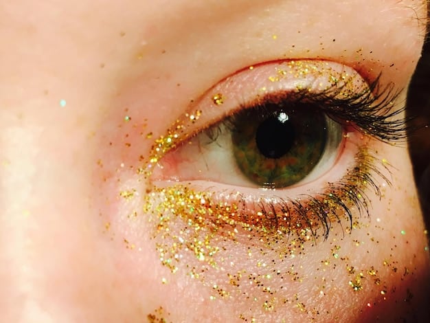 A close-up of a hazel eye with gold and green flecks, featuring soft, smoky plum eyeshadow that subtly enhances the green, paired with a touch of shimmering gold on the inner corner to illuminate the amber tones.