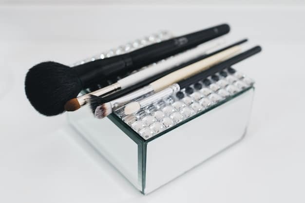 A neatly organized set of clean, dry makeup brushes of various types (powder, blush, eyeshadow, foundation) arranged in a stylish, clear acrylic holder on a vanity.