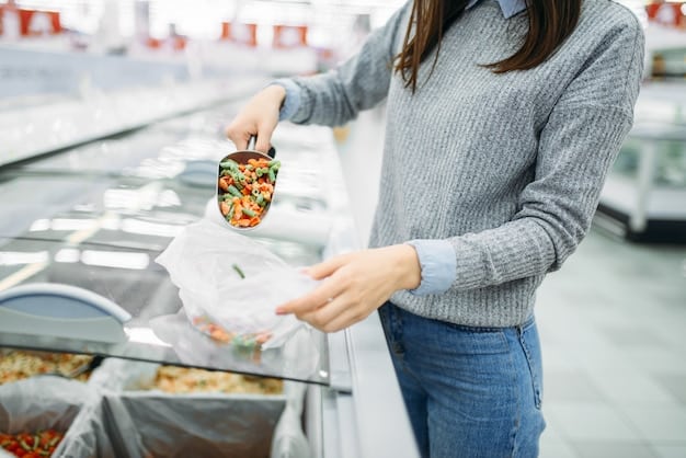 A person's hand reaching for a bag of frozen mixed vegetables in a grocery store's freezer aisle, emphasizing affordable and convenient options for healthy eating. The background is slightly blurred to keep focus on the action.