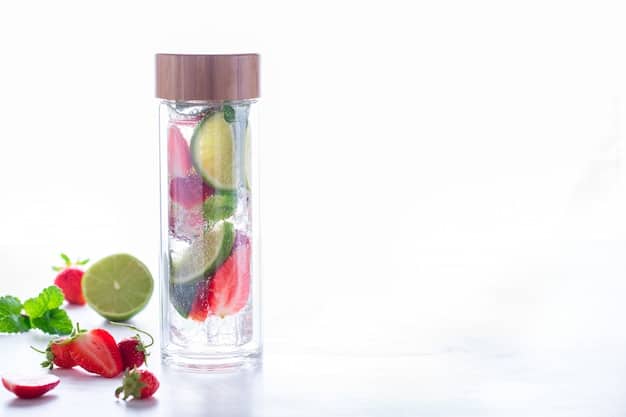 A vibrant flat lay of a variety of colorful fruits (berries, citrus slices, cucumber, mint leaves) arranged around a sleek, transparent water bottle, emphasizing infused water and fresh ingredients.