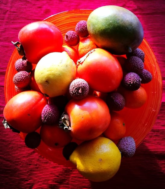 A close-up shot of a variety of colorful fresh fruits and vegetables, such as vibrant red bell peppers, crisp green cucumbers, juicy blueberries, and bright orange carrots, arranged appealingly on a wooden board, emphasizing fresh, whole foods.