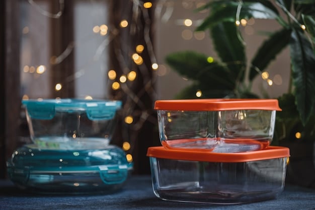 A close-up of various hermetically sealed, clear glass meal prep containers filled with colorful, organized healthy meals, stacked neatly in a refrigerator.