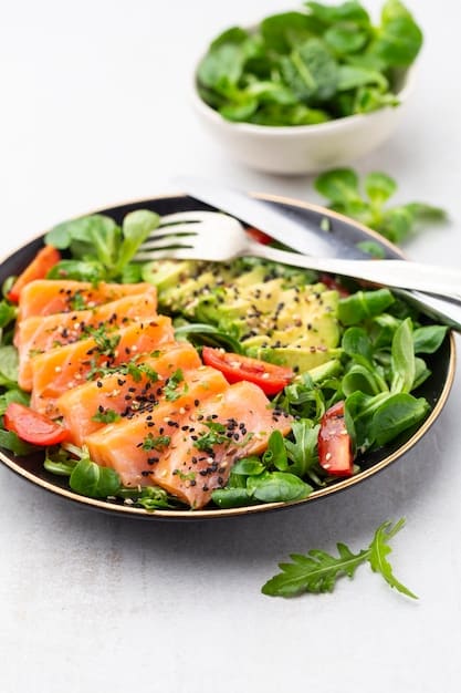 A vibrant bowl of salmon with avocado, quinoa, and leafy greens, showcasing a well-balanced meal rich in healthy fats, fresh and appealing to the eye.
