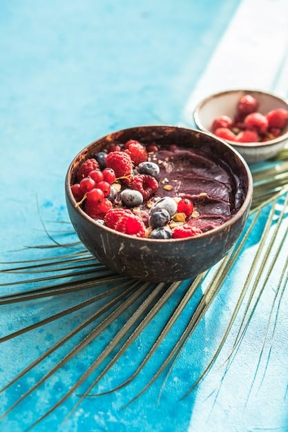 A close-up of vibrant açaí berries in a bowl, blended into a smoothie or served as açaí bowls with fresh fruit toppings, highlighting their rich purple color and appealing texture.