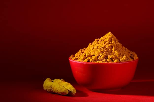 A bowl of vibrant yellow turmeric powder next to a whole turmeric root, with subtle background elements hinting at spices or traditional uses, emphasizing its color and source.