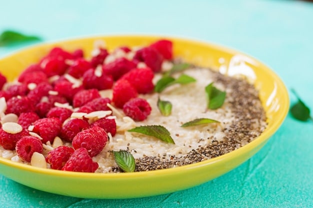 A close-up shot of a healthy and colorful breakfast bowl filled with oatmeal, fresh berries, chia seeds, and nuts, representing a balanced meal for sustained energy.