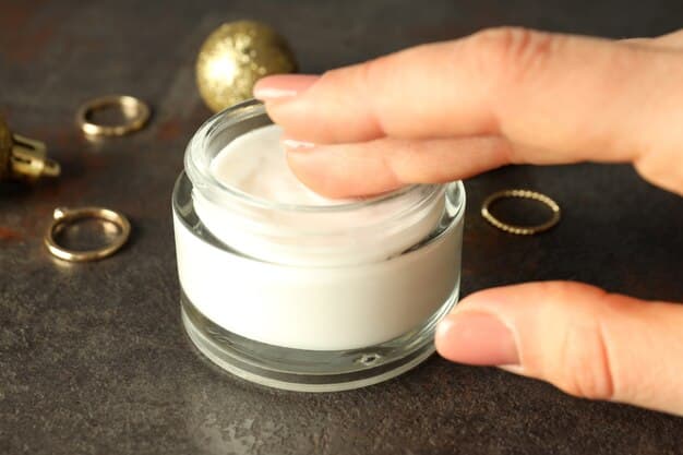A close-up of hands applying a thick, luxurious moisturizer to dry skin, emphasizing relief and hydration. The product jar is visible but blurred, keeping the focus on the application.