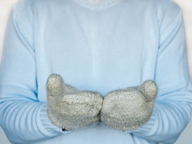 A person's hands wearing warm mittens, but with exposed fingertips showing perfectly hydrated and glowing skin, framed against a blurred winter outdoor scene, symbolizing healthy skin despite the cold.