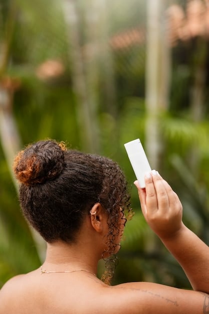 A woman applying a leave-in conditioner to her damp hair, with emphasis on the product's lightweight texture and hair looking hydrated and protected from the sun.