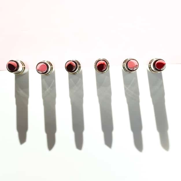 A set of nails with a light peach base, each featuring a single, clean black geometric line diagonally across the tip, creating a modern, minimalist look.