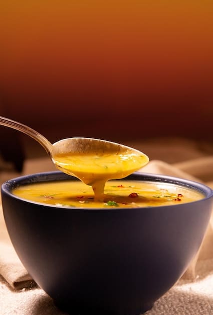 A warm, inviting bowl of turmeric chicken soup with fresh herbs, steam rising, subtly suggesting comfort and immune-boosting properties.