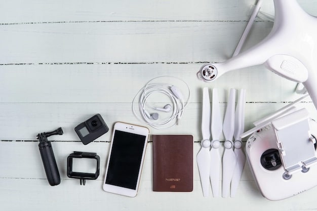 A detailed flat lay of essential travel tech, including a sleek power bank, universal travel adapter, noise-canceling headphones, a compact e-reader, and a foldable phone stand, all ready for a summer trip.