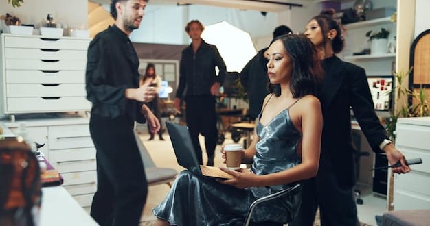 A diverse group of fashion industry professionals mingling backstage at a NYFW show, with elaborate outfits and stylists making final adjustments.