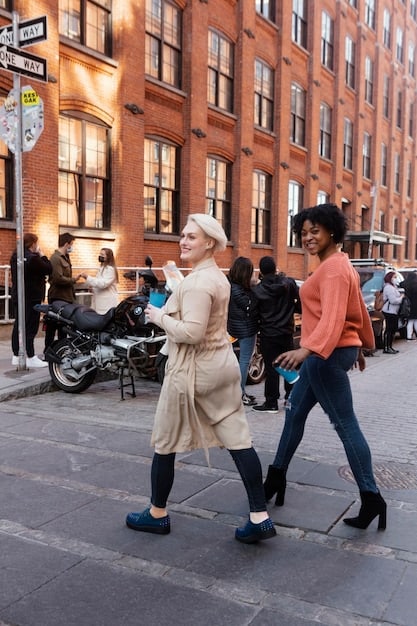 A bustling street scene outside a New York Fashion Week venue, with fashion photographers capturing street style and influencers posing.