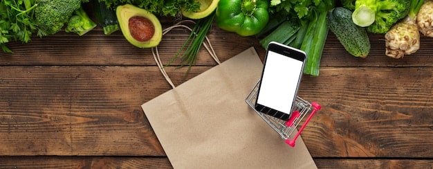 A detailed flat lay of a modern smartphone displaying a shopping app, next to a reusable shopping bag and fresh produce, symbolizing conscious consumerism and digital integration.