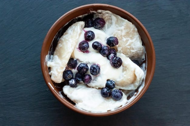 Close-up shot of a creamy bowl of plain yogurt topped with fresh blueberries and a sprinkle of granola, highlighting the texture and healthy additions. The background is blurred with soft, natural light, emphasizing the freshness and appeal of a gut-friendly snack.