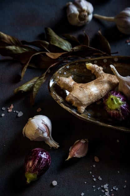 A close-up shot of fresh garlic cloves and ginger root on a dark rustic wooden background, highlighting their natural texture and healthy appeal.