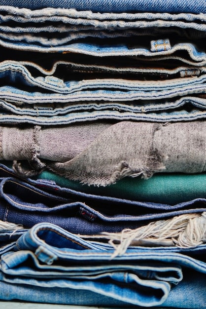 A close-up shot of various sustainable fabrics, including organic cotton, recycled denim, and plant-based dyed textiles, highlighting their textures and eco-friendly appeal. Focus on the soft, natural colors and the materials' unique weaves. The fabrics represent the eco-conscious aspect of Spring 2025: How to Refresh Your Wardrobe with 5 Key Seasonal Trends and Save Up to 20% on New Arrivals.