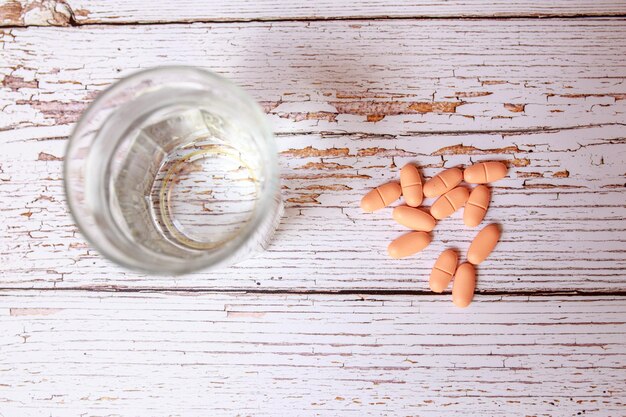 Close-up of vitamin D supplement capsules on a wooden table, bathed in soft, natural light. The focus is on the texture of the capsules and the warm tones of the wood, emphasizing the natural source of the supplement.