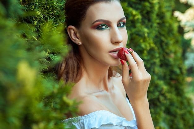A woman with olive skin wearing a berry-toned lipstick, standing in a garden with ripe berries on the bushes behind her. She is wearing a dark green coat and has a natural, slightly mysterious expression. This captures the essence of Fall Beauty: 4 Bold Lipstick Shades to Make a Statement This Season.