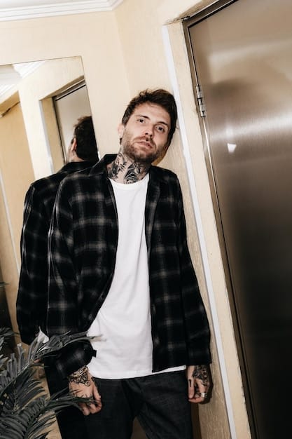 A person is layering an oversized flannel shirt over a plain white t-shirt and black skinny jeans. They are also wearing chunky combat boots. The setting is a casual, urban environment featuring Breaking: The Return of the 90s Grunge Look - What's Hot and What's Not in 2025.