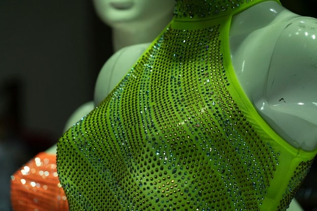 A close-up shot of a 3D printer creating a complex dress design with intricate patterns in a fashion studio. The image emphasizes the precision and detail achievable with 3D printing technology in the context of Fashion Tech: How 3D Printing and AI are Revolutionizing the Industry.