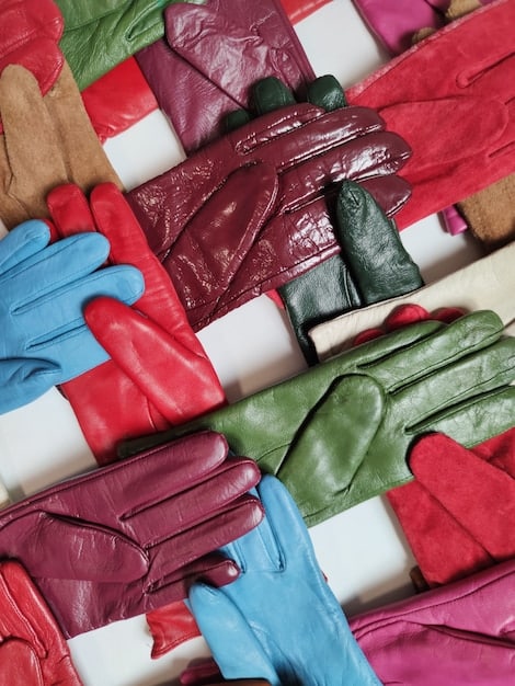 A close-up shot of a gloved hand sorting through piles of colorful textile waste in a recycling facility. The image conveys the environmental impact of the fashion industry, particularly textile waste and the need for circular economies and sustainable practices related to The Ethics of Fashion: Are Brands Doing Enough to Protect Workers and the Environment?