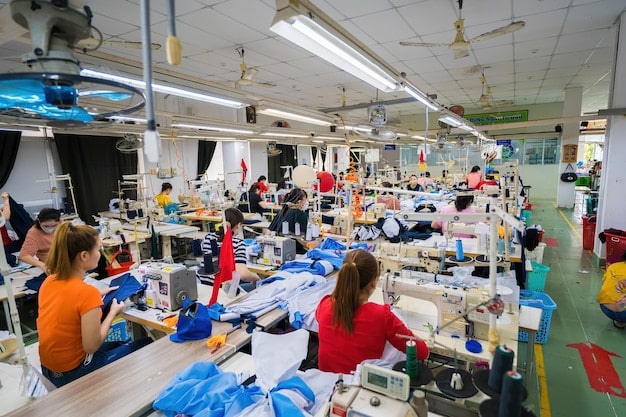 A shot of a clothing factory with bright, clean workspaces, showcasing workers diligently sewing and inspecting garments. The scene emphasizes ethical production practices and fair labor standards in The Business of Fashion: How Brands are Adapting to a Changing Retail Landscape.