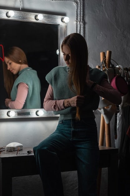A bustling backstage scene at NYFW, with stylists making last-minute adjustments to models' outfits, makeup artists applying finishing touches, and racks of designer clothes in the background, showing organized chaos.